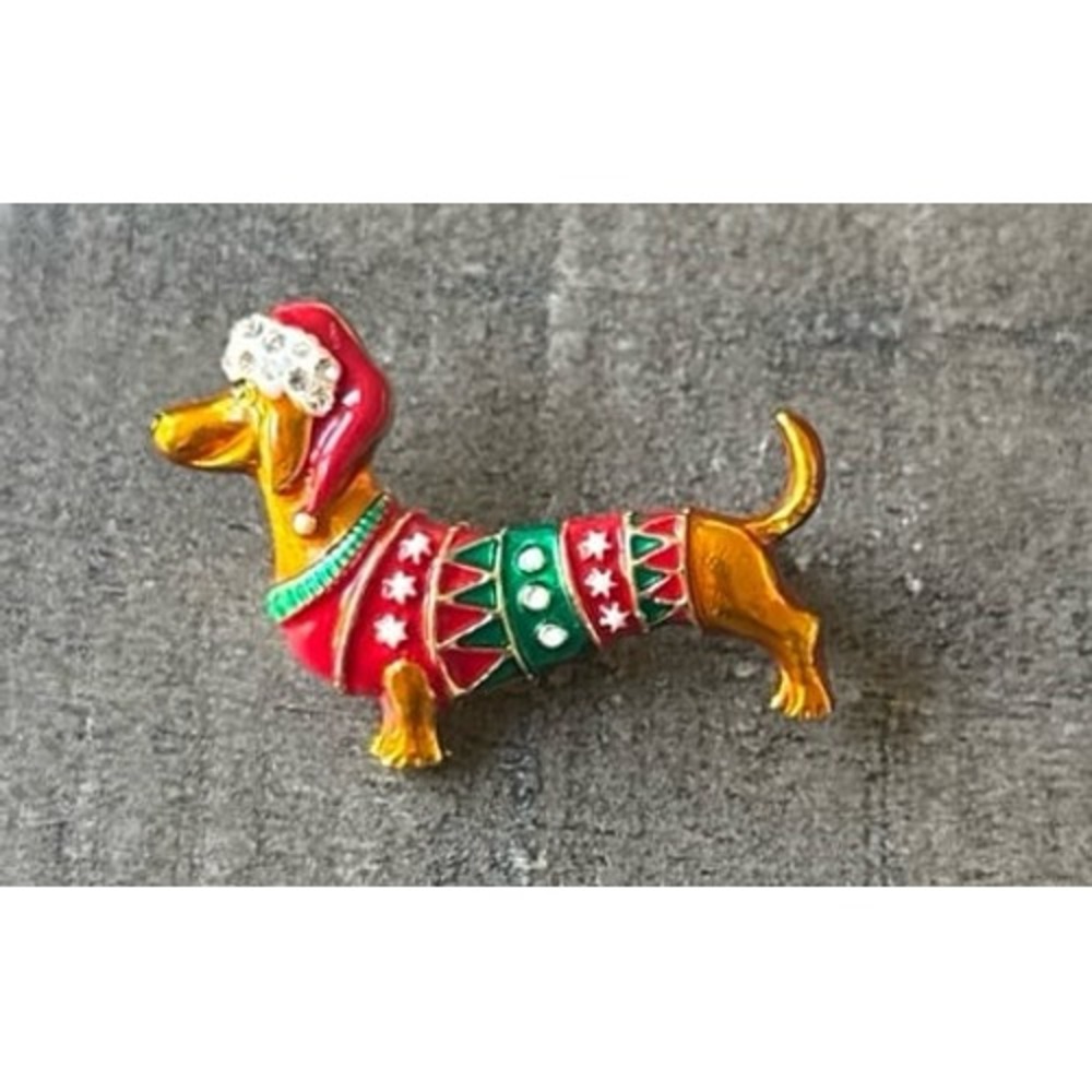 Festive enamel dachshund brooch wearing a holiday sweater and a Santa hat